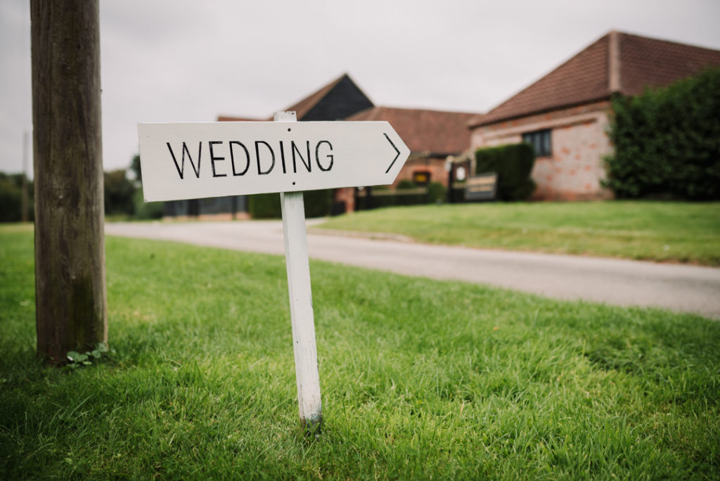 a handmade wedding sign points the way to Coltsfoot farm retreat 