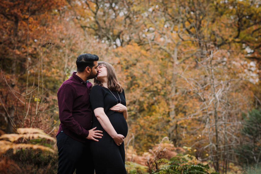 pregnancy mum turns to kiss her partner in Hertfordshire woods