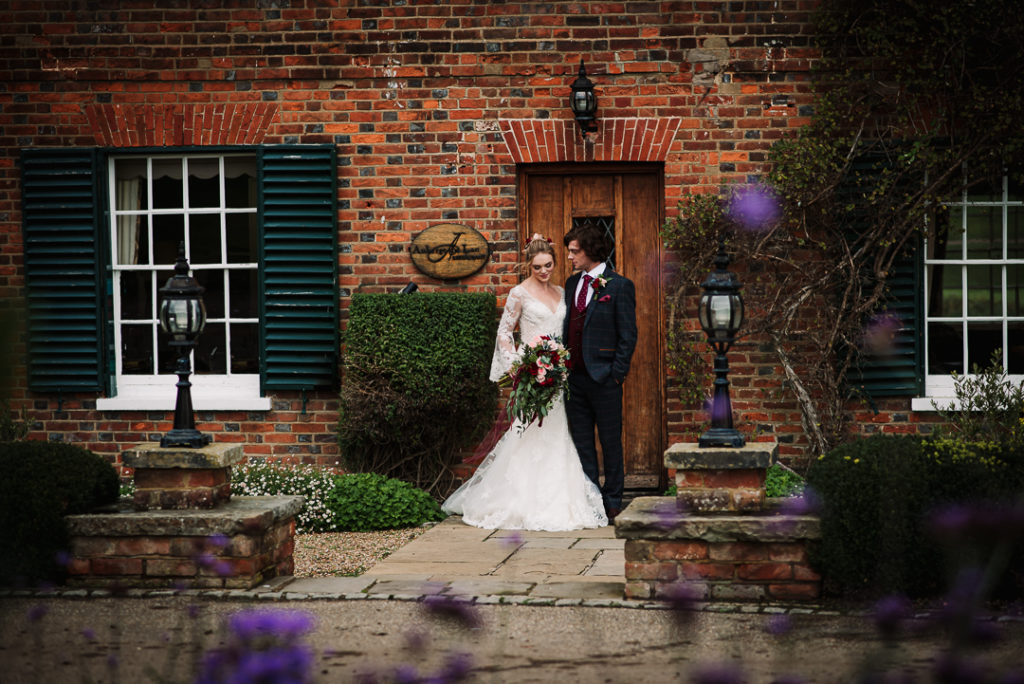 Hertfordshire wedding venue Auberge du lac provides a backdrop for bride and groom portraits