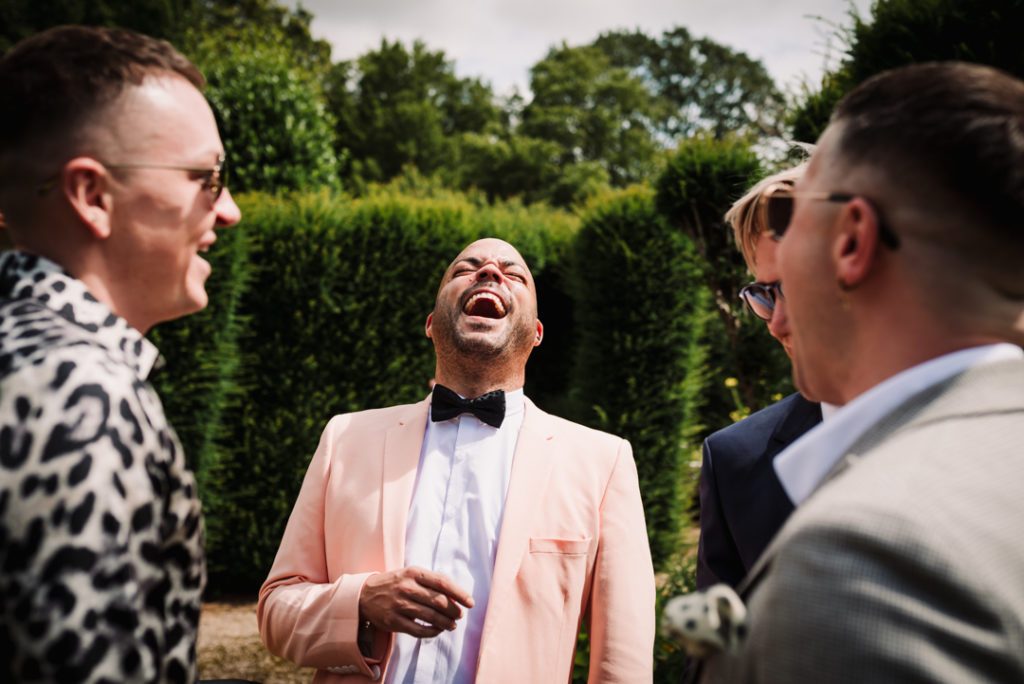 Guest laughs before the same sex wedding ceremony