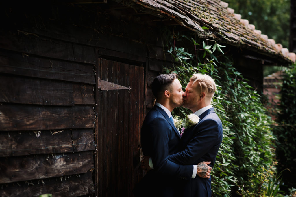 groom and groom kiss captured by hertfordshire wedding photographer