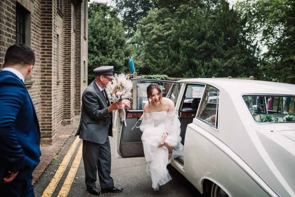 Bride arrives at her Luton Hoo wedding in a white rolls royce