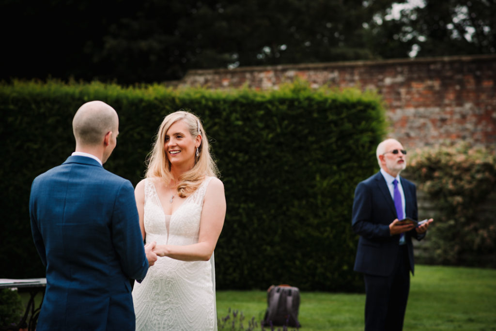 marriage vows being said by couple at their Wadhurst Castle Wedding 