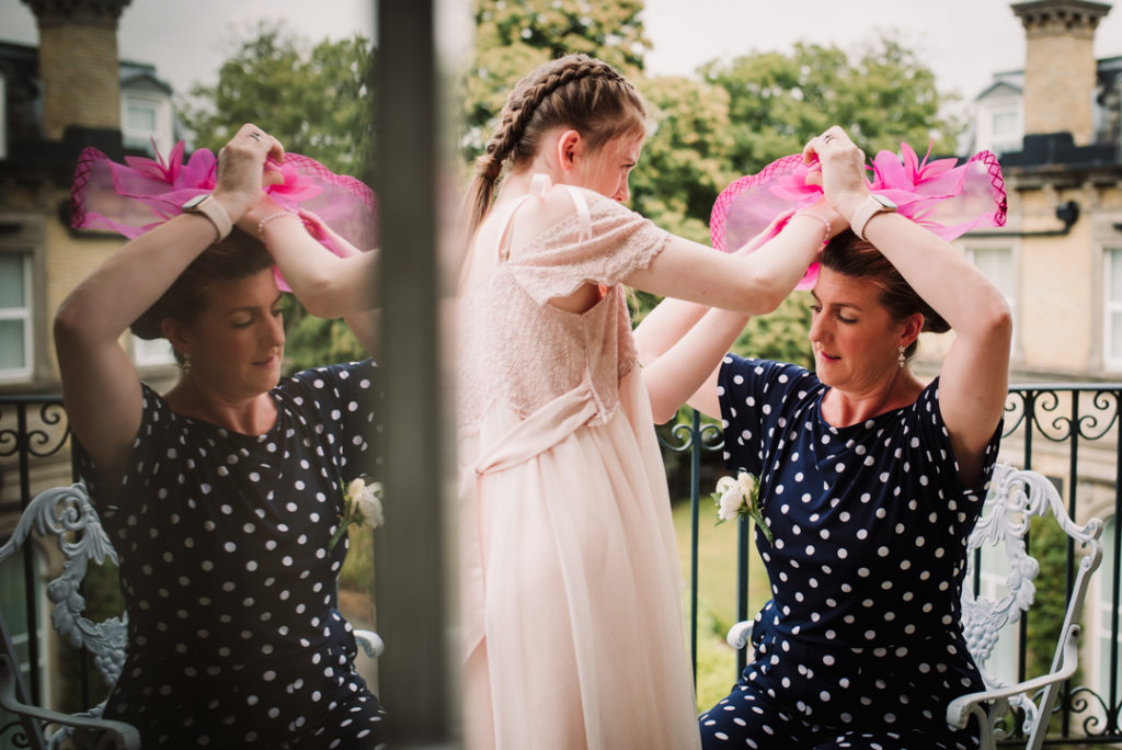 bridesmaid fixes her mums hat before the Wadhurst Castle Wedding 