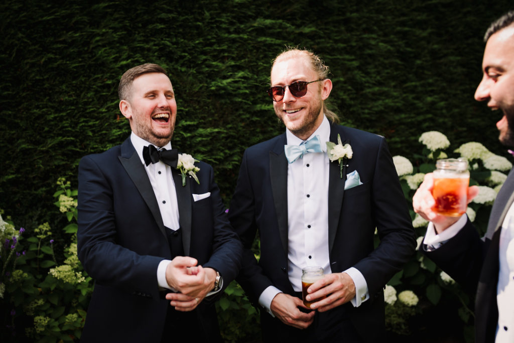 groom and his best men enjoy a laugh after the wedding ceremony