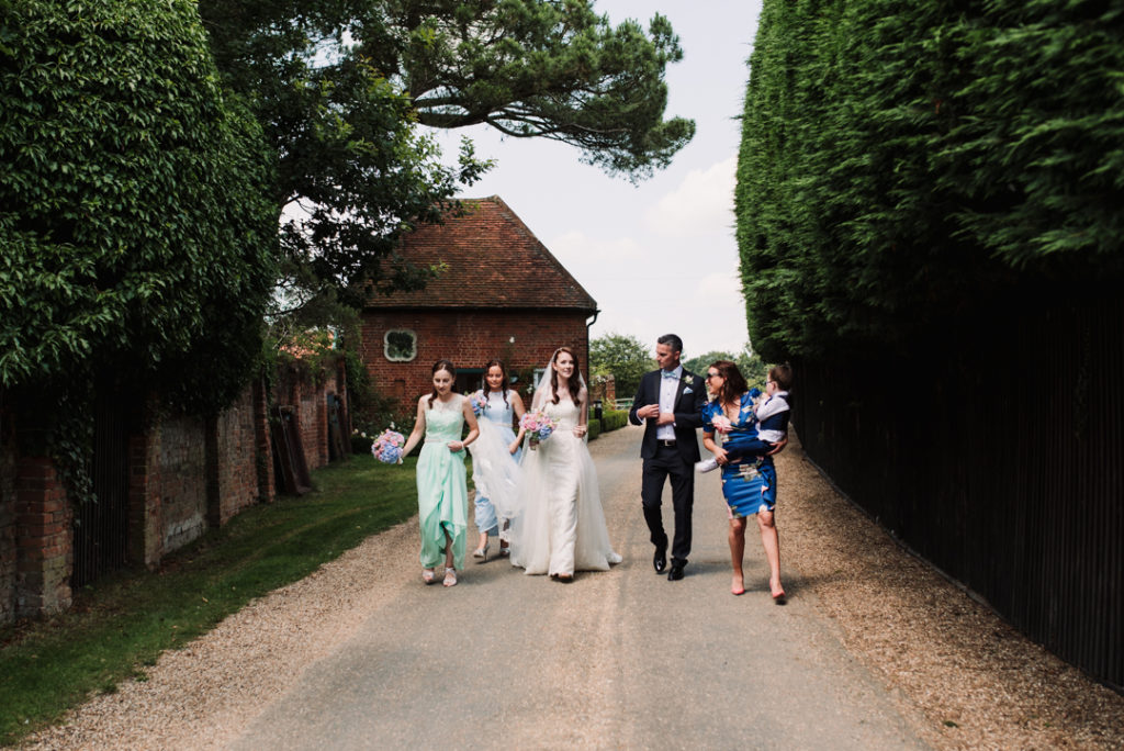 the bridal party make their way to the gaynes park wedding ceremony