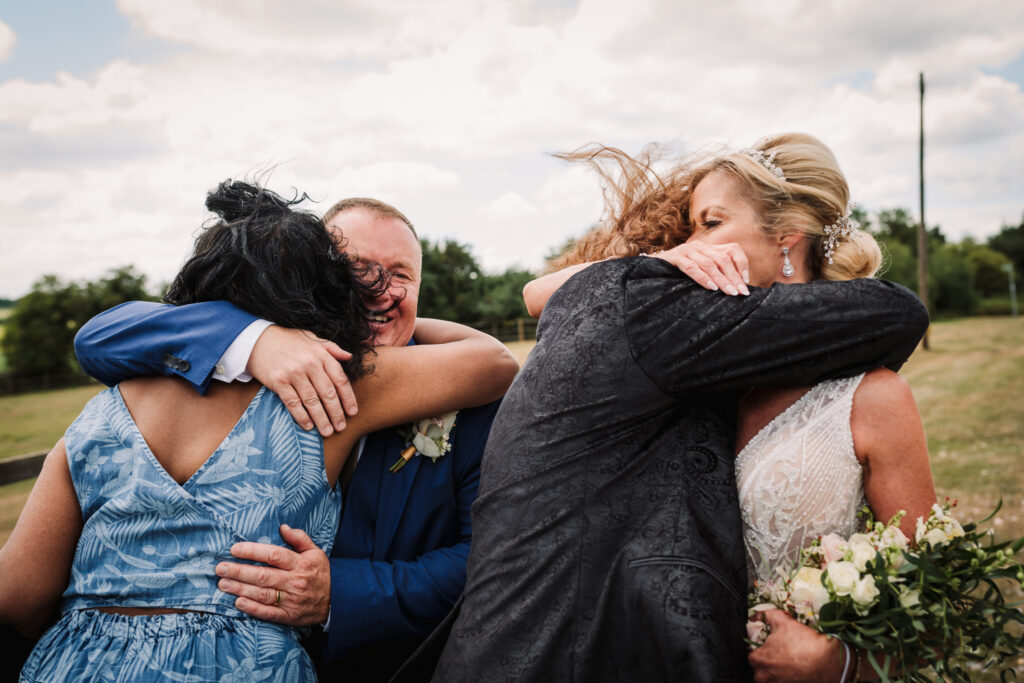 Hugging guests at Hertfordshire wedding
