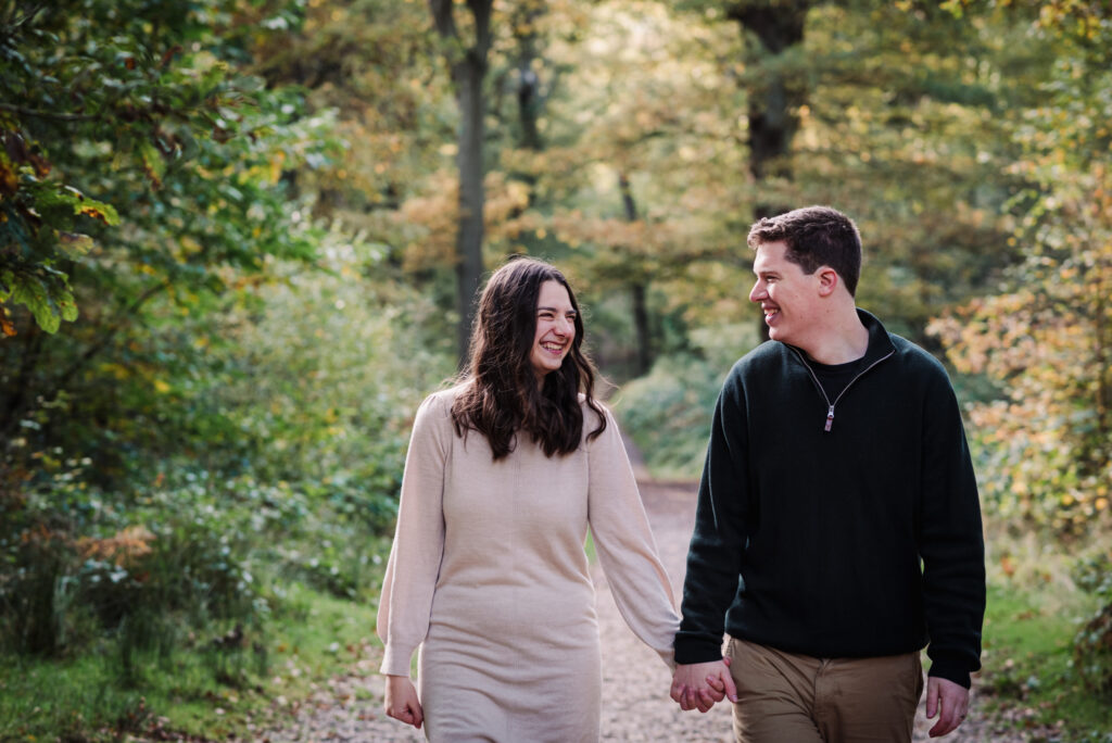 newly engaged couple walk hand in hand during their Hertfordshire engagement photo shoot
