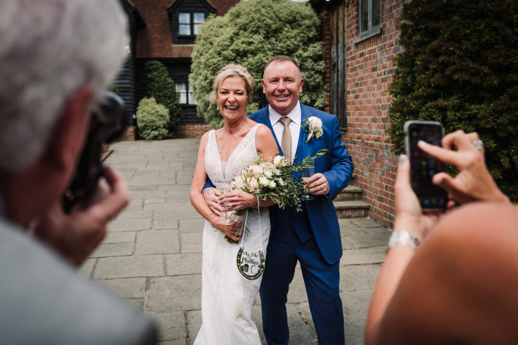 Wedding guests take photographs of the happy couple at Coltsfoot Country Retreat