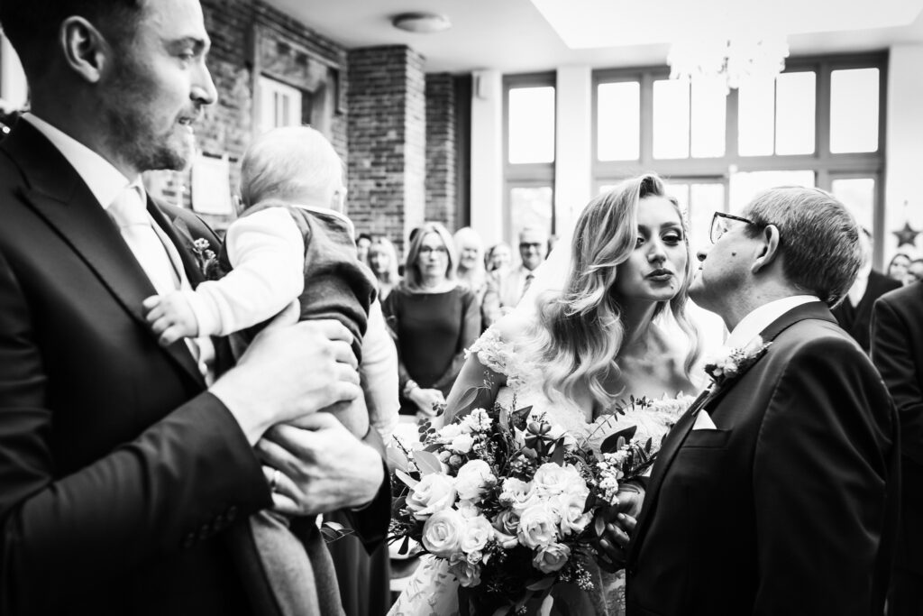 offley place wedding photographer captures the bride kissing her dad as she walks up the aisle