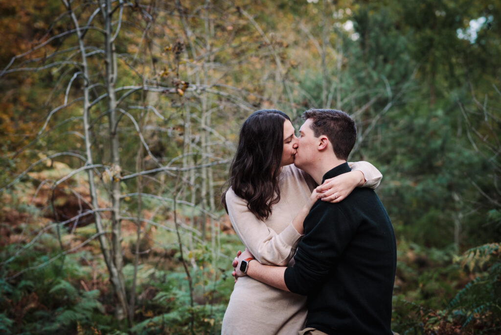 couple kiss during their  engagement photo shoot in hertfordshire