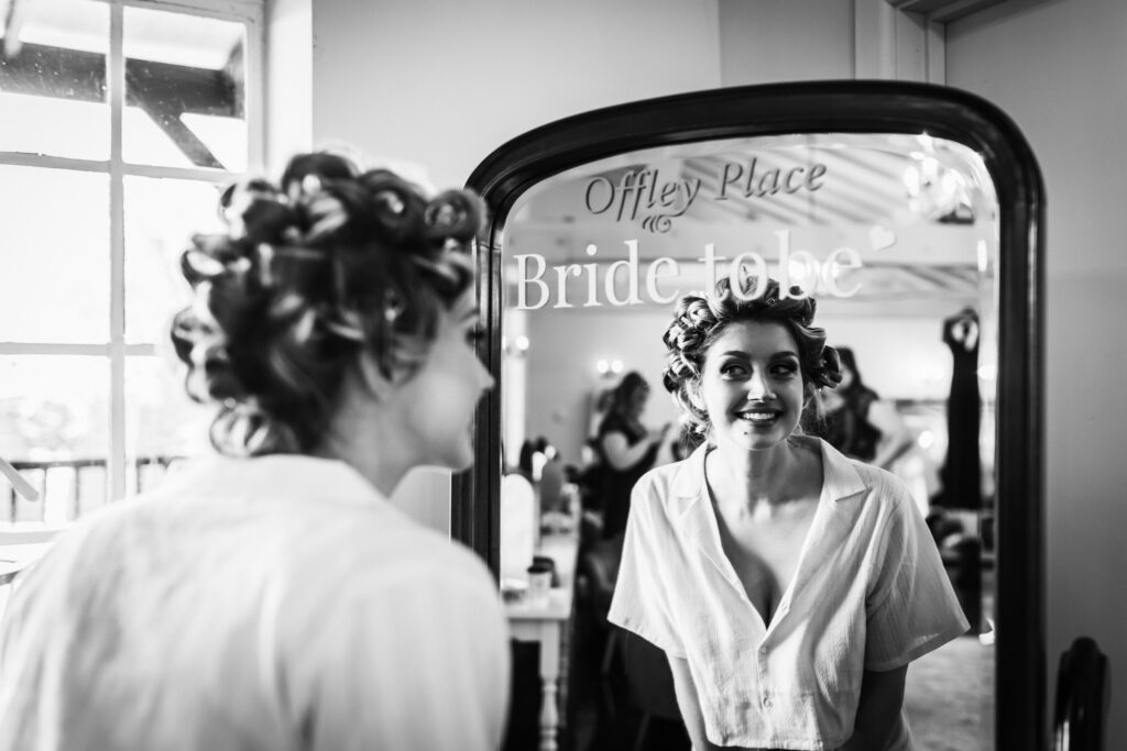 offley place wedding photographer captures bride looking in the mirror after her make up has been done