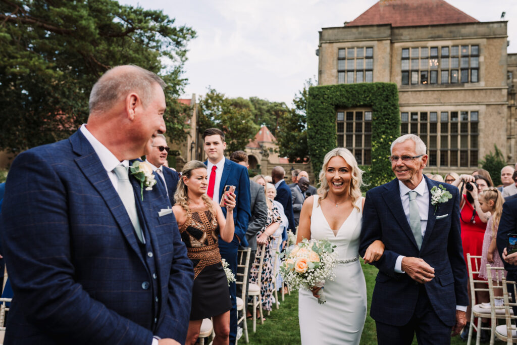 Fanhams Hall wedding photographer captures bride and her dad walking down the aisle