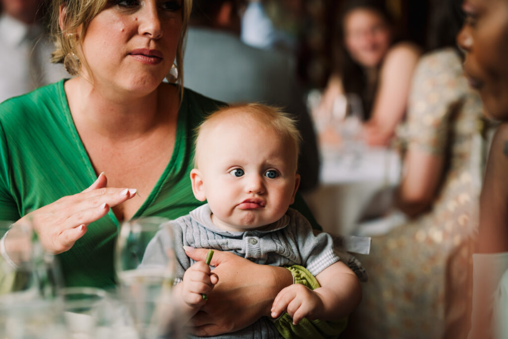 Baby pulls a funny face at Gosfield HAll wedding breakfast