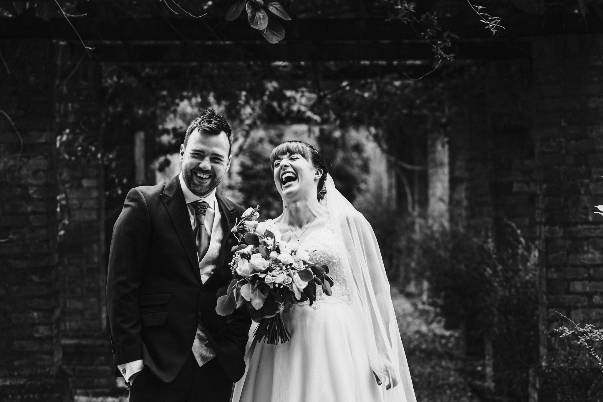 bride and groom laugh during their hertfordshire wedding reception