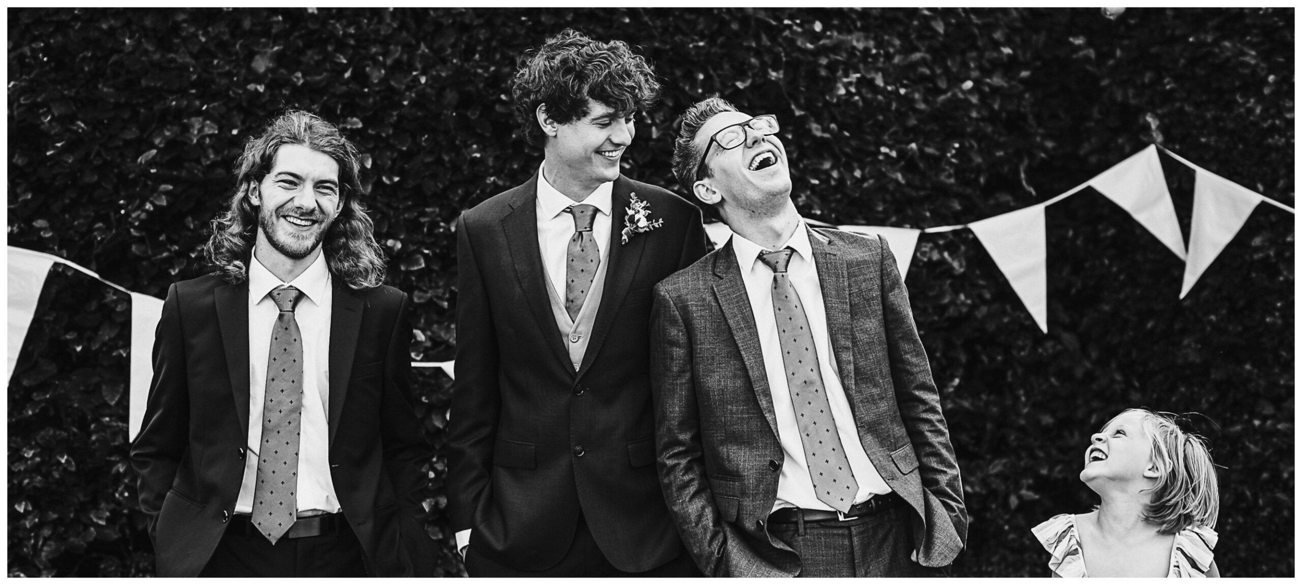 groomsmen laugh at Hertfordshire wedding reception