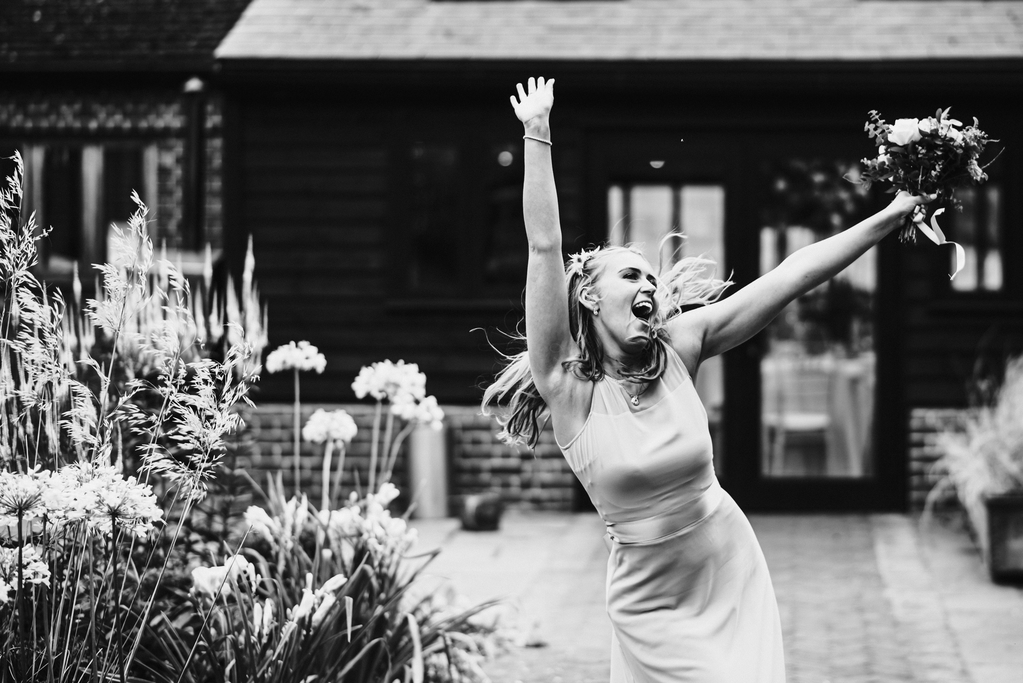 Bridesmaid photographed dancing at Hertfordshire wedding 