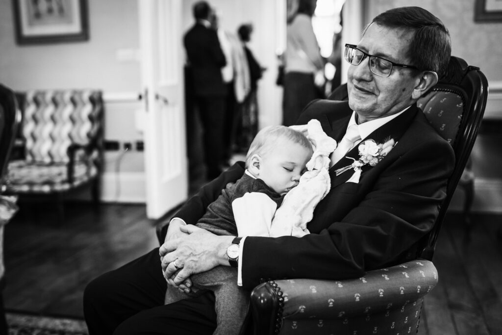 granddad and grandson enjoy a little nap at Offley Place wedding
