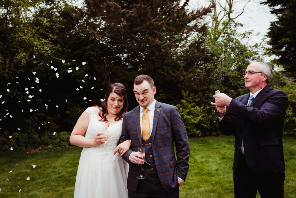 sheene milll wedding photographer captures dad throwing confetti