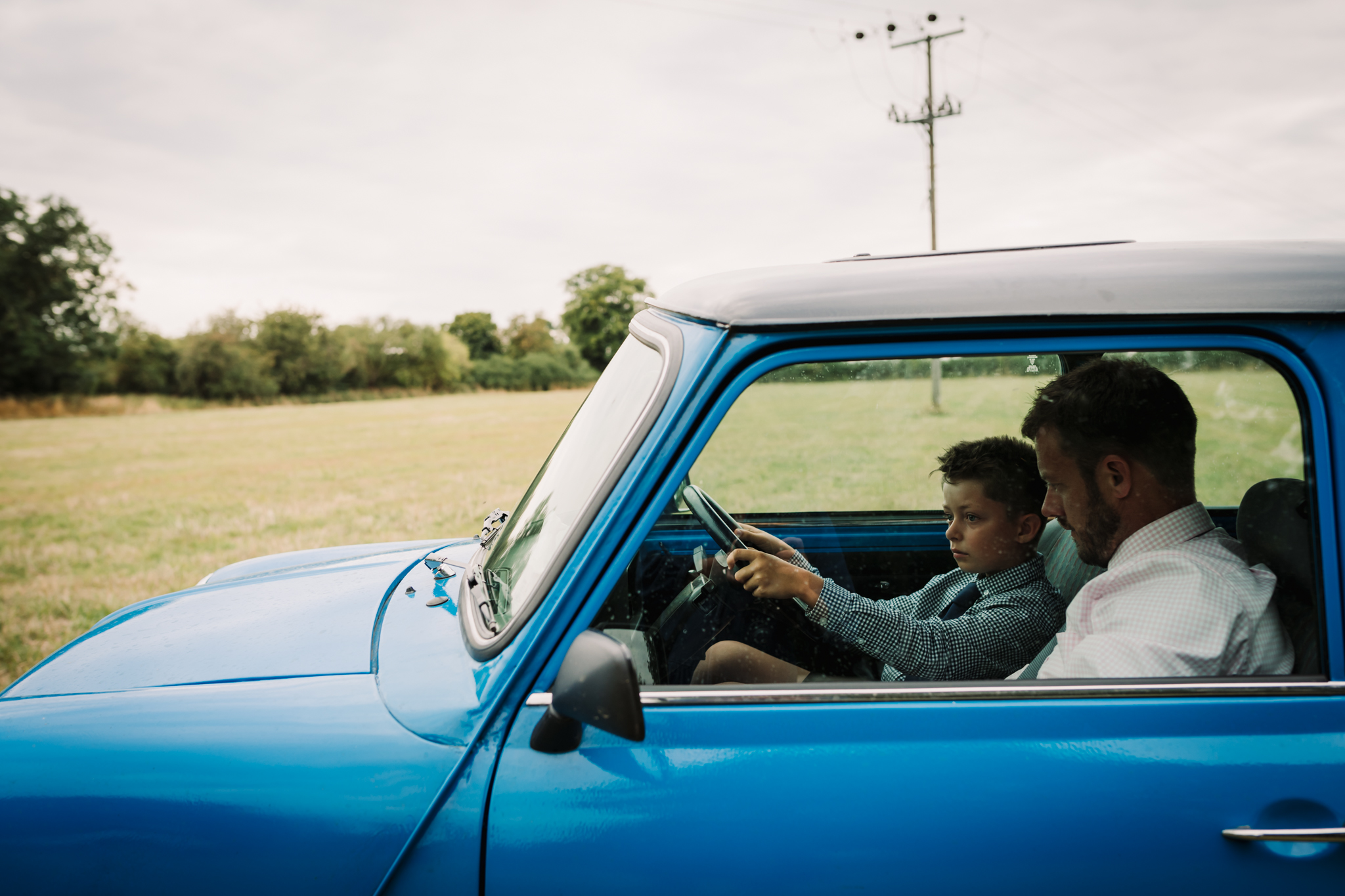 Hertfordshire Garden Party wedding Photographer captures young boy driving