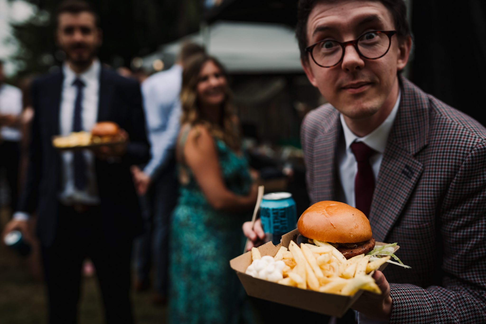 Hertfordshire Garden Party wedding Photographer captures guest showing off his food