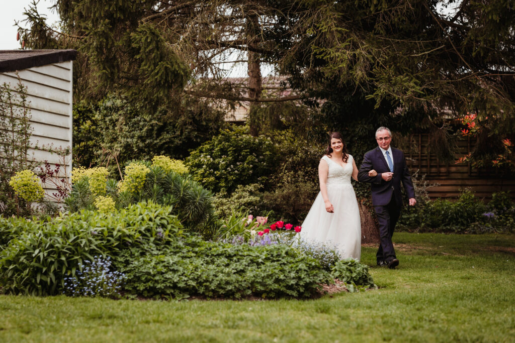 photographer documents bride and her dad walking to the sheene mill wedding ceremony