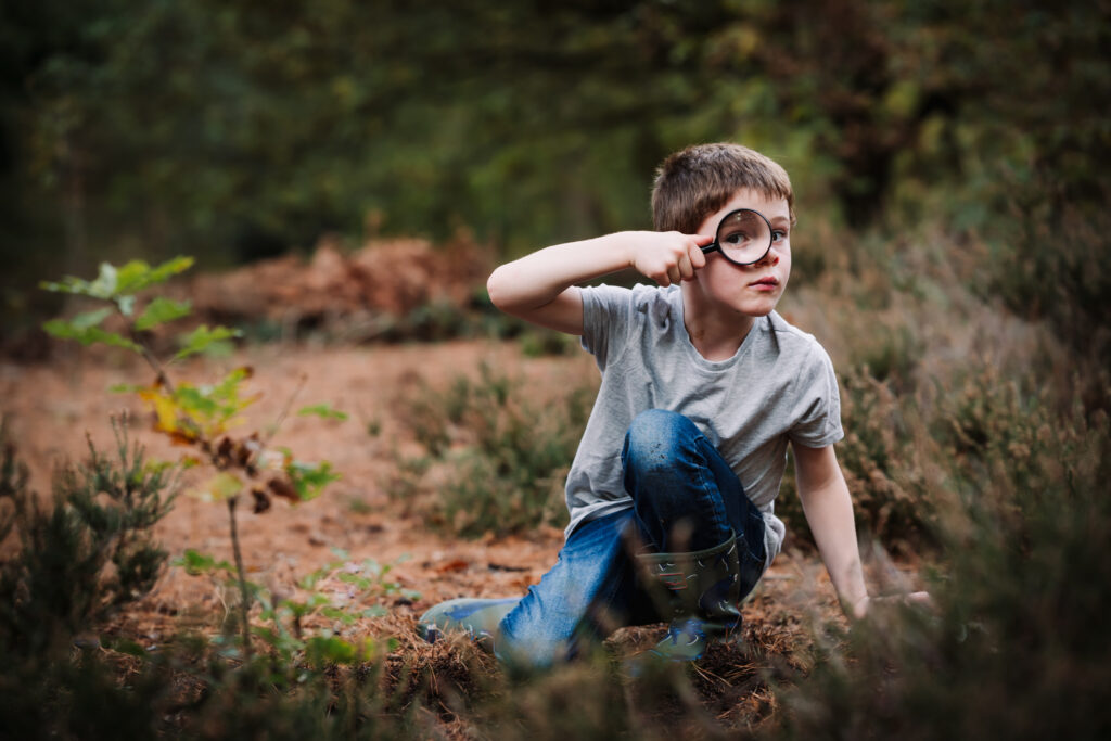 family photographer captures a moment of contemplation from a young boy during his family photo shoot in hertfordshire