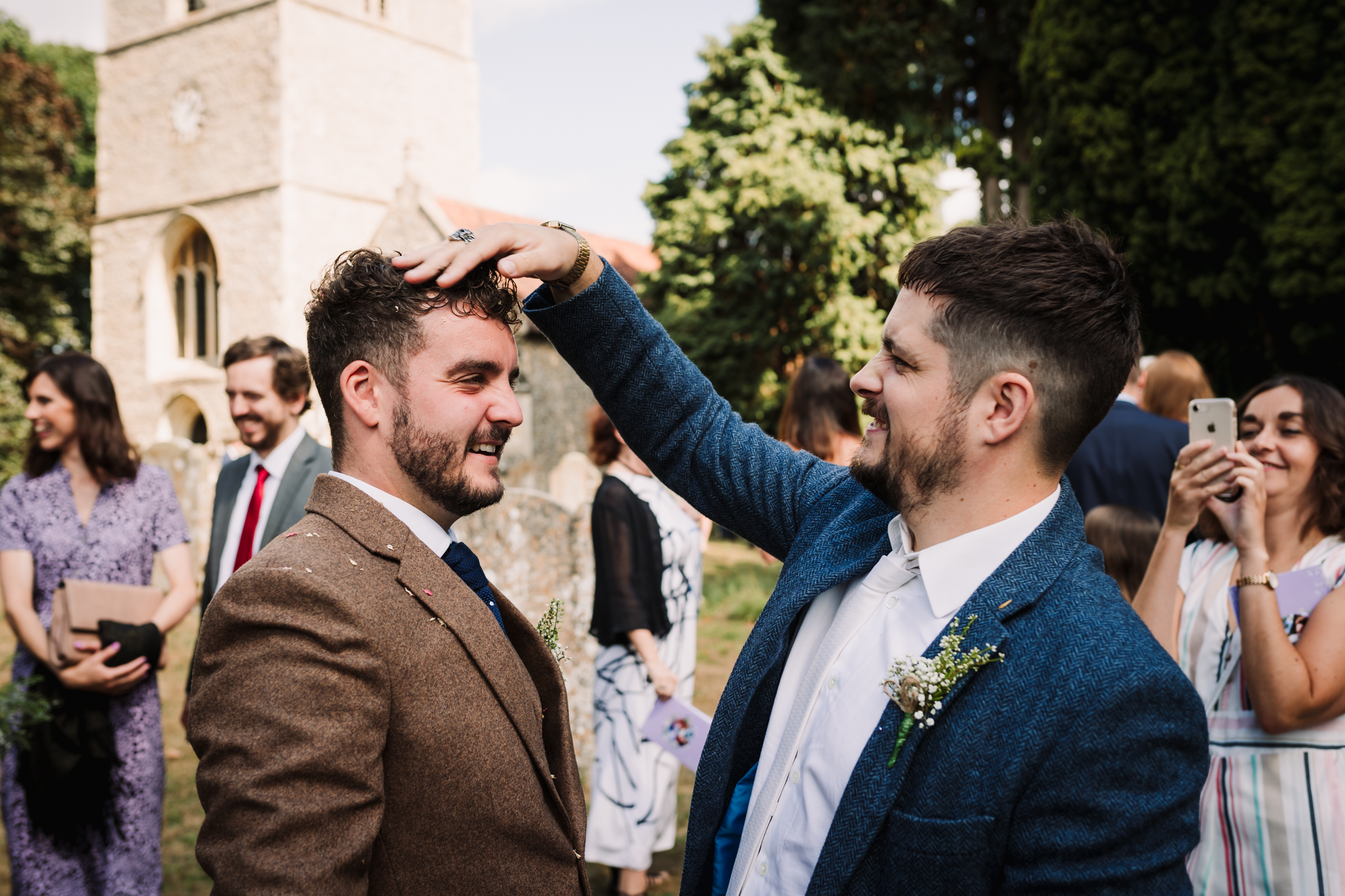 best man removes confetti from hertfordshire grooms hair