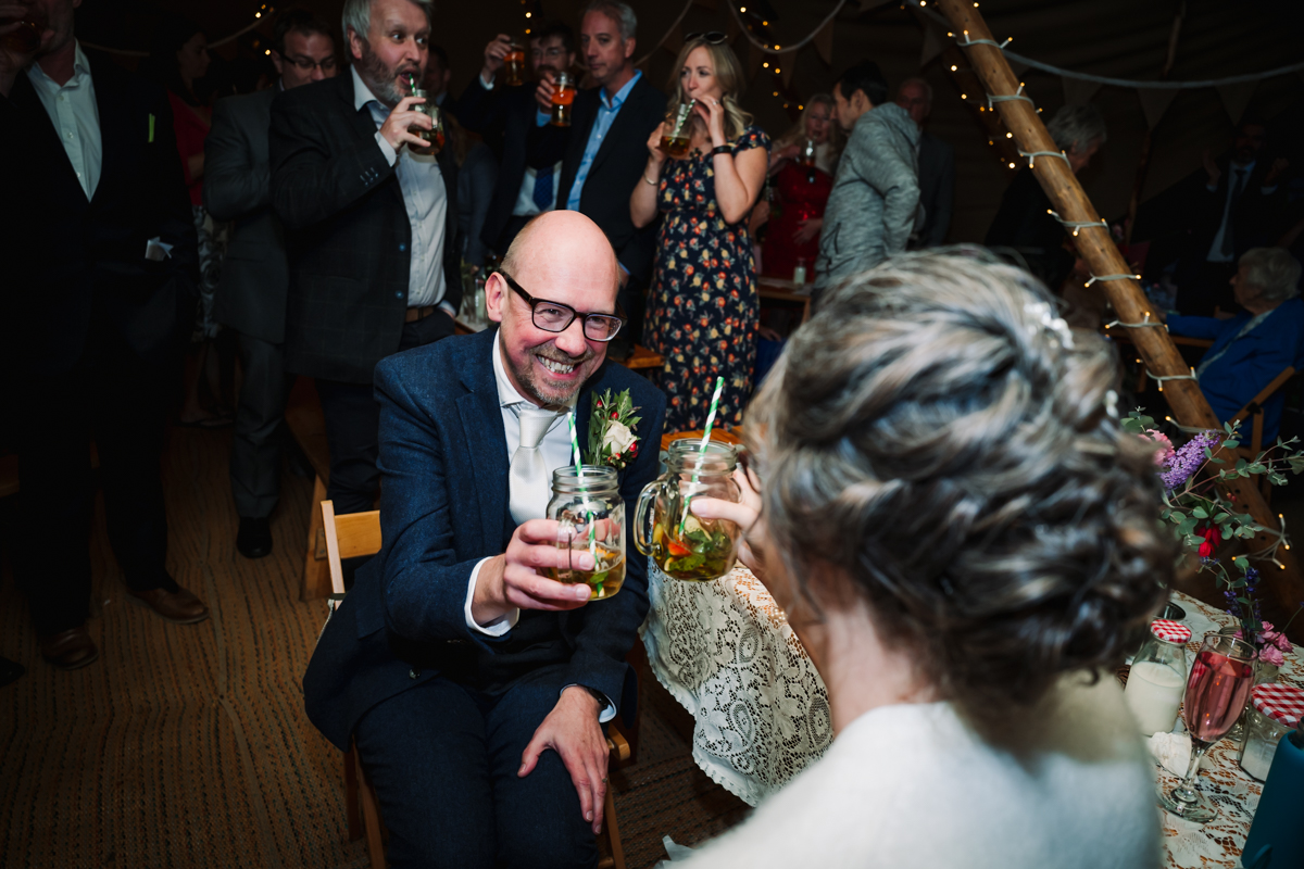 Bride and groom say cheers after the speeches at their Rowly Barn wedding