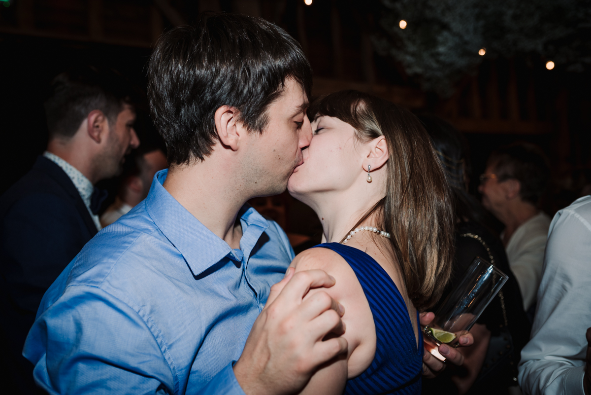 Guests kiss at wedding reception at Redcoats 