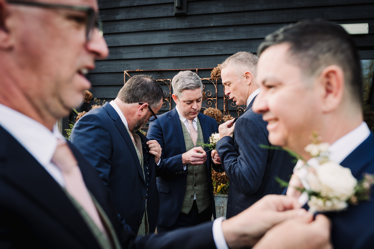 Hertfordshire wedding photographer captures groomsmen getting ready before the ceremony