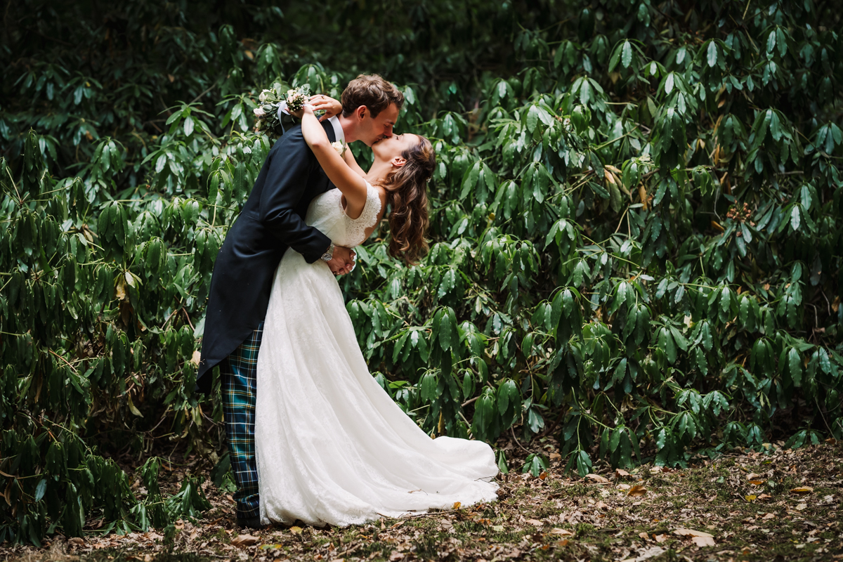 Bride and groom kiss during their photography portraits