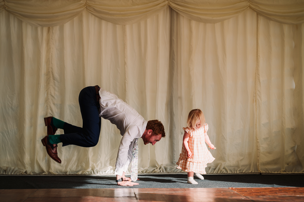 Dad and daughter play during the wedding breakfast in Hertfordshire