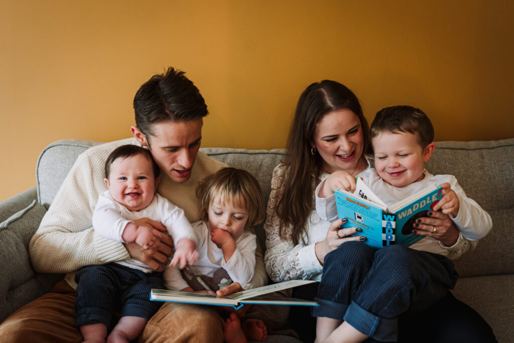 Hertfordshire family share a book together during their photography session at home
