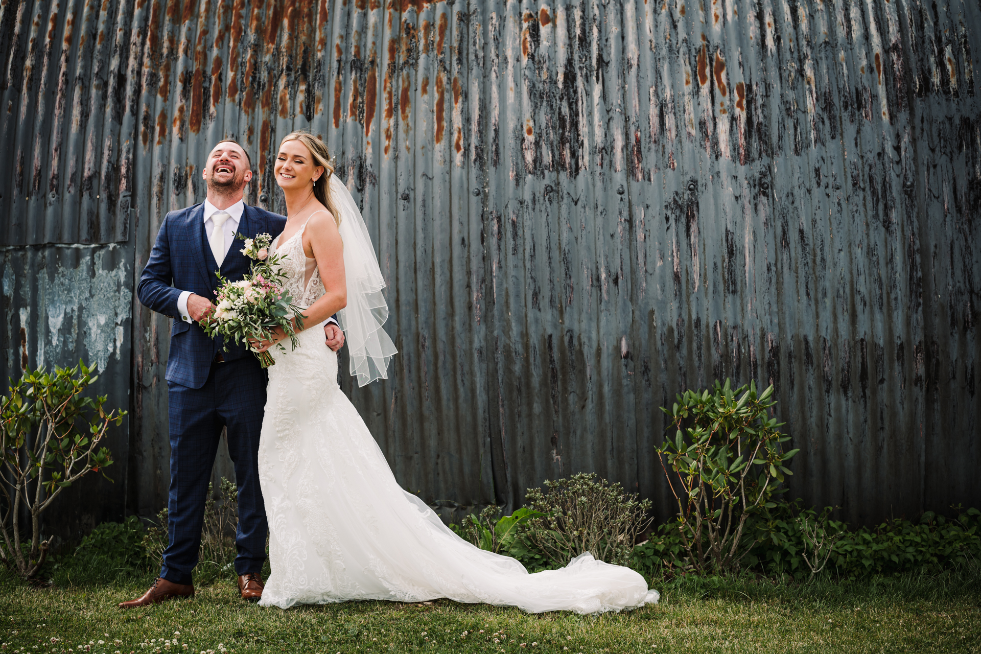 Bride and groom share a joke during their wedding day photography