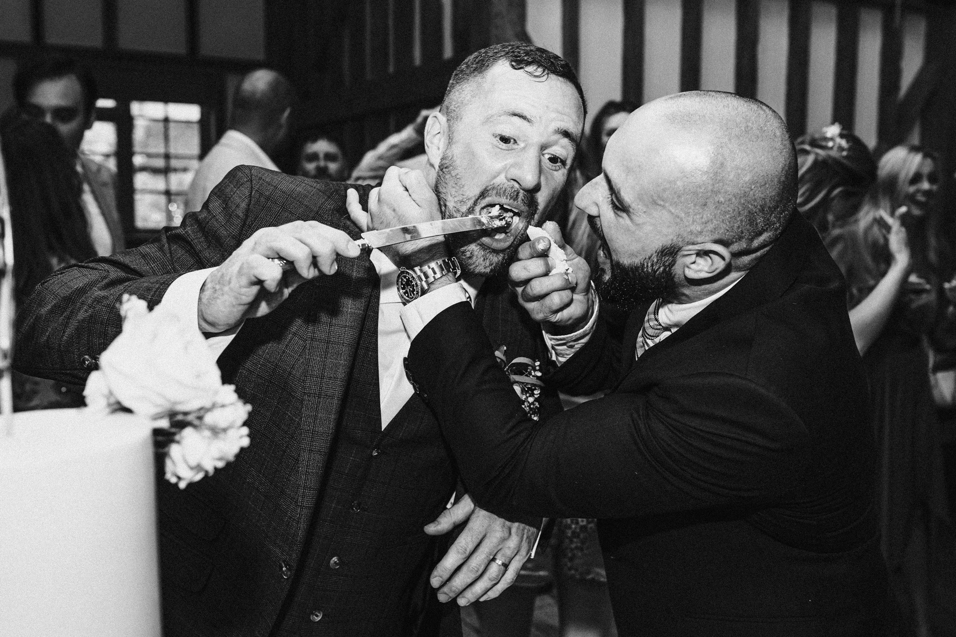 Wedding cake is devoured by groom and his friends