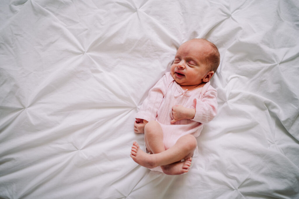 newborn baby sleeps peacefully at home in hitchin during her photography session