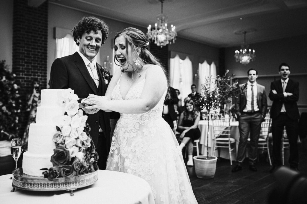bride and groom cut the cake at Offley Place wedding reception
