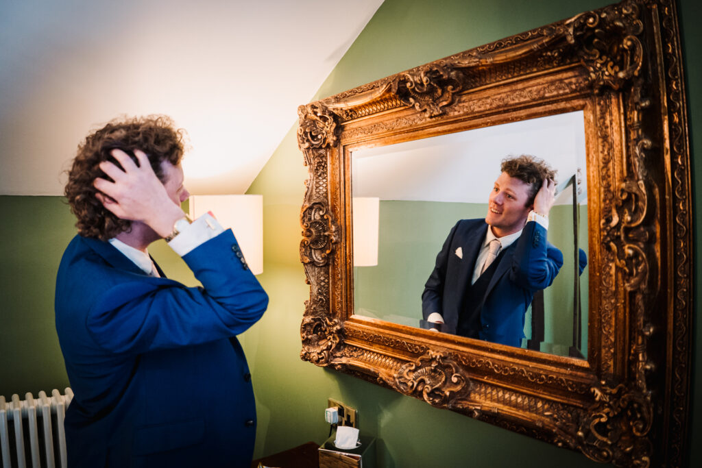 groom prepares for his wedding day at Offley Place in Hitchin