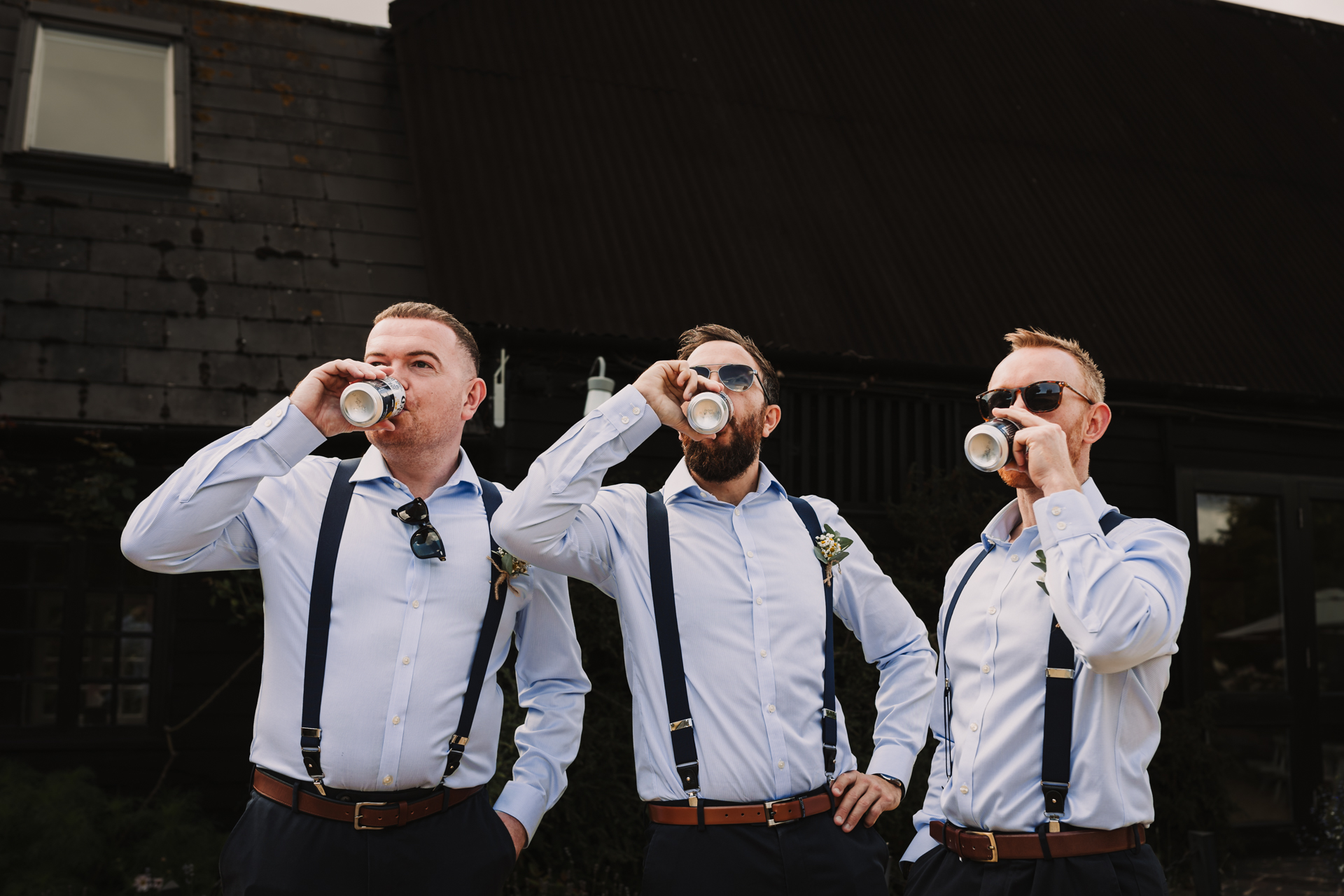 groomsmen enjoy a beer before the wedding ceremony